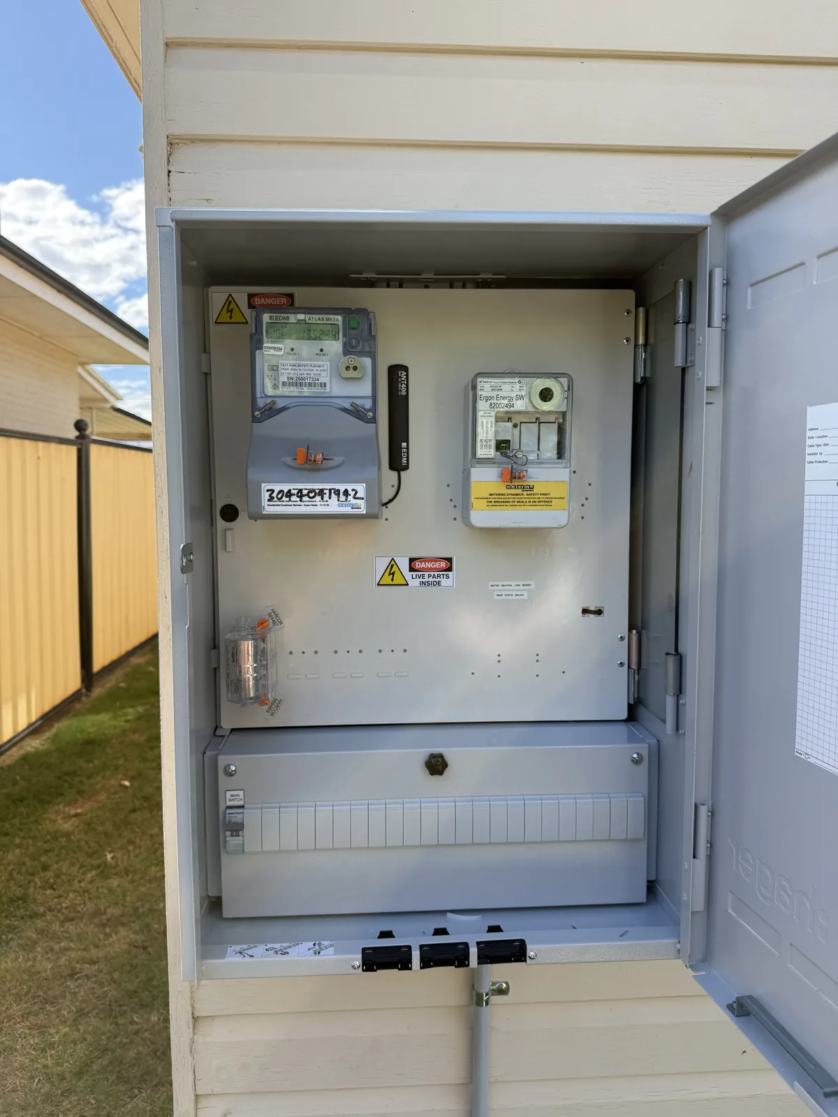 Crowded old meter box rebuilt into a modern weatherproof enclosure with new metering and protection. Before and after from the same wall.