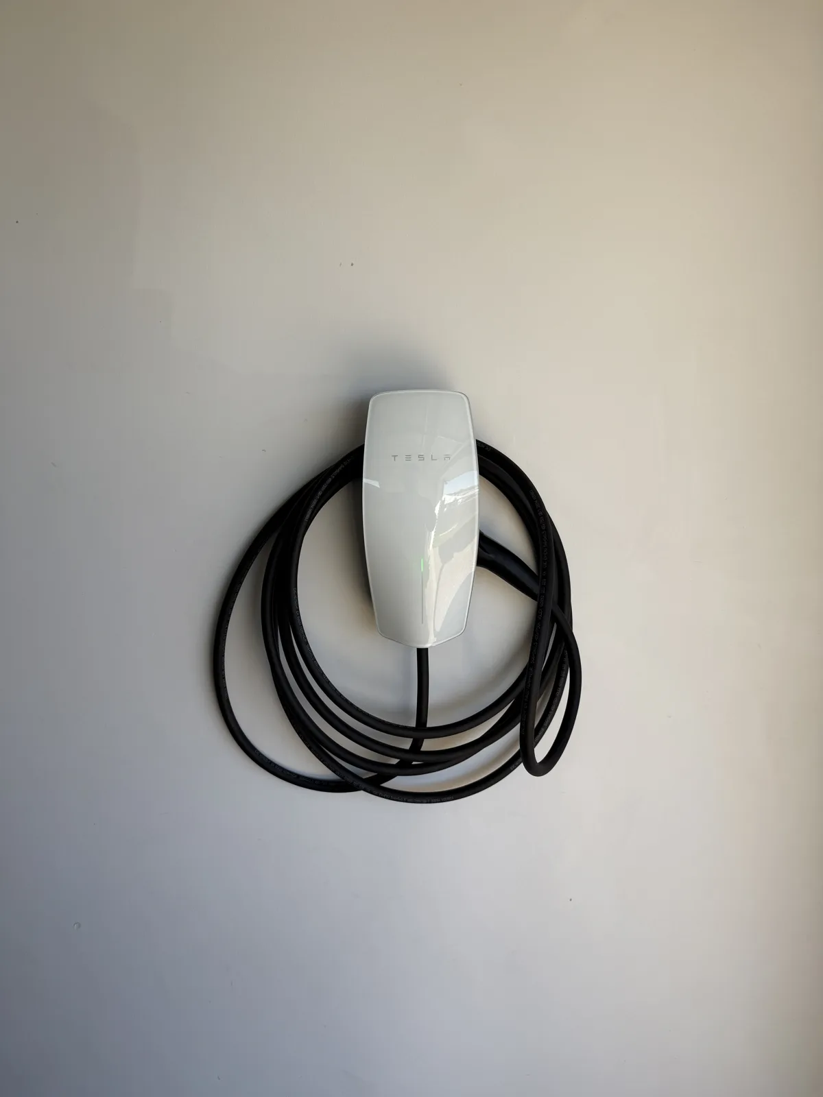 Tesla Wall Connector installed on a dedicated circuit for overnight home charging. Clean flush wall mount with concealed cabling.